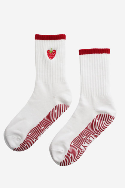 White socks with red accents and a strawberry logo