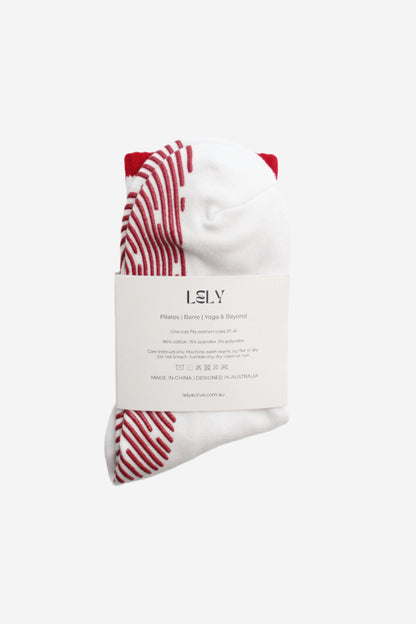 Product packaging with white sock with red grip design