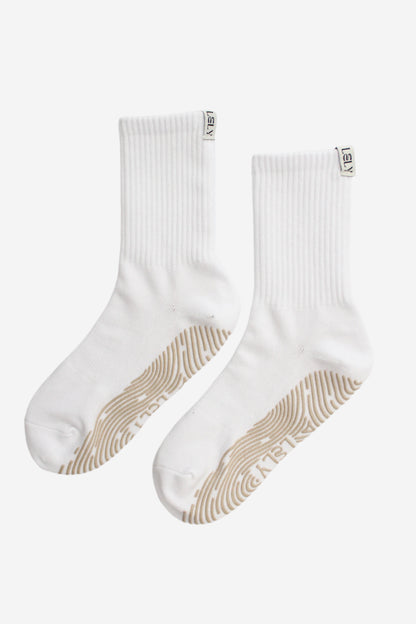 White socks with beige grips and Lely woven label