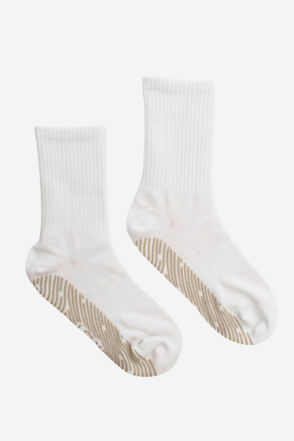 Pair of white crew socks with beige grips