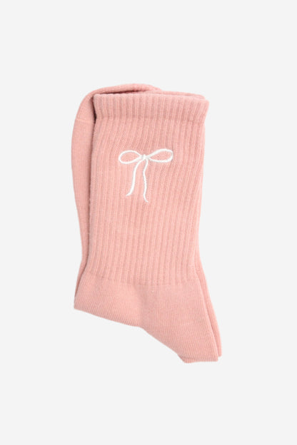Pink ribbed sock with a white bow design