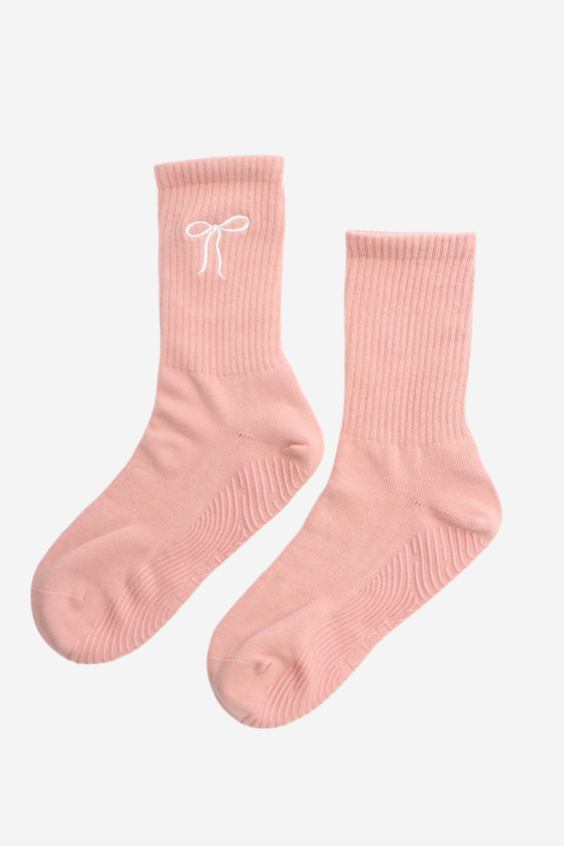 Pair of pink socks with a white bow
