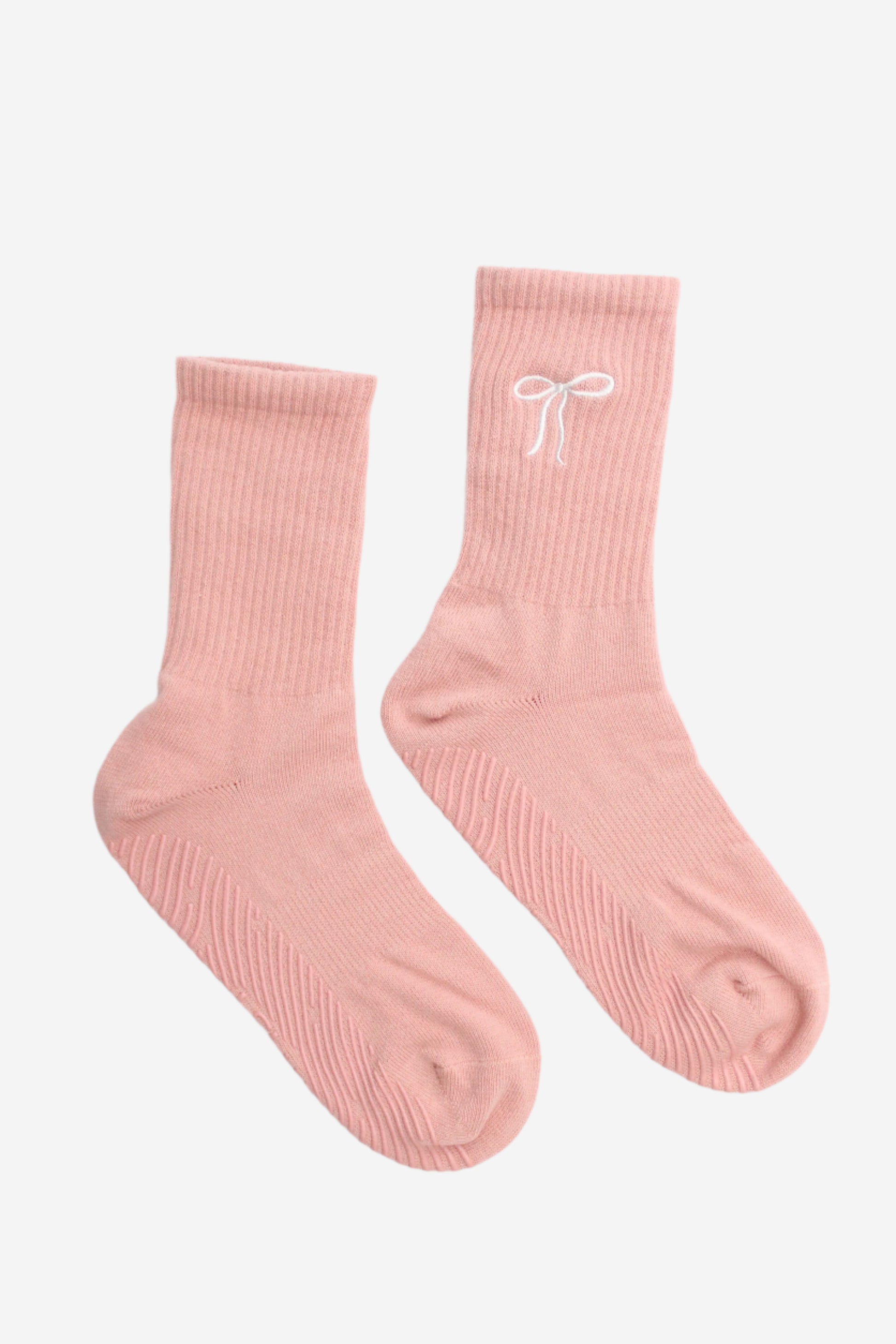 Pair of pink socks with a white bow design