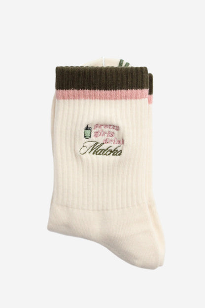 White sock with green top and pink middle section with pattern that says pretty girls drink matcha