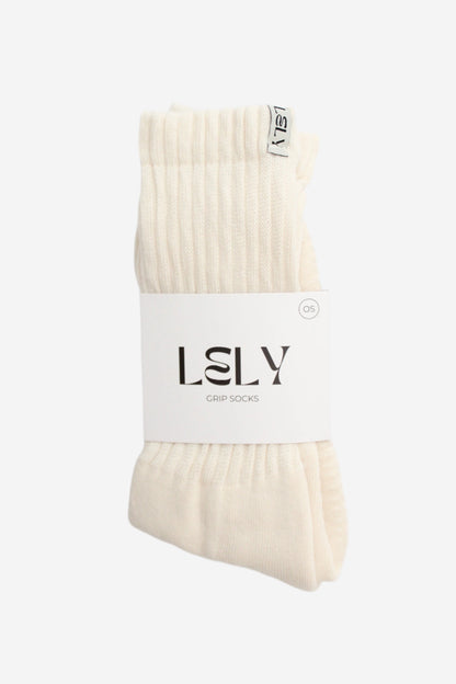 Pair of cream slouch knit socks with a white label