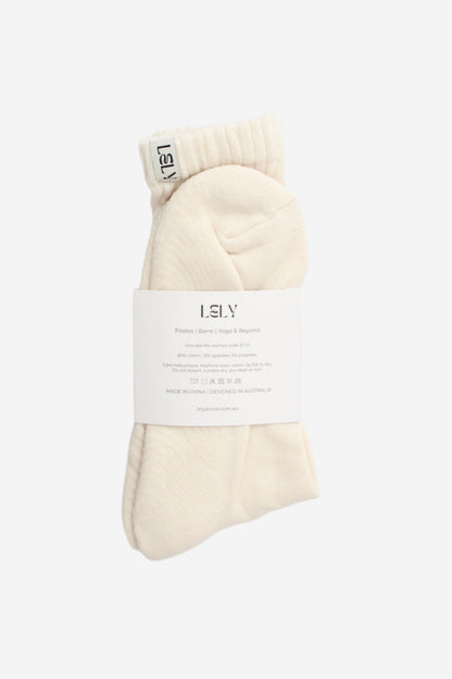 Pair of cream-colored slouch knit socks with a label 