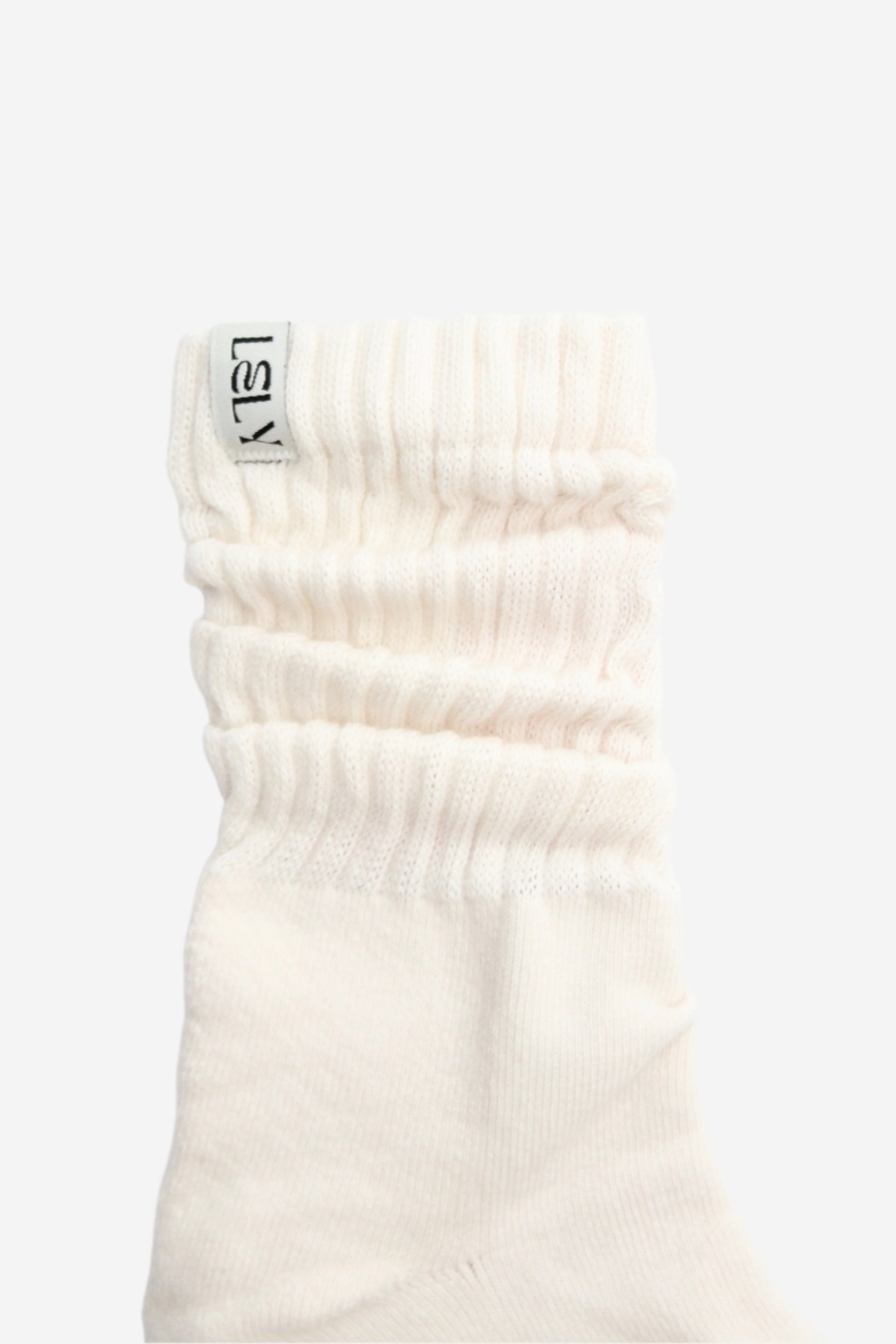 White slouch knit sock with a brand Lely label 