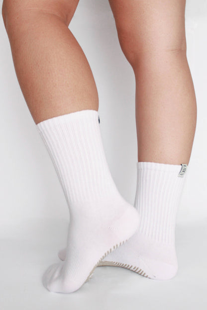 White socks worn by a person on a light gray background