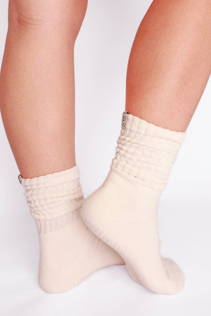 White socks worn by a person on a light gray background