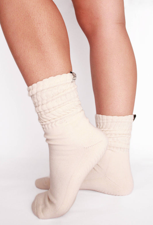 White socks worn by a person on a light gray background